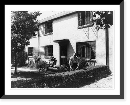 Man clipping hedge, woman and child on porch, Greenbelt, Md. Classic, Antique Wall Art
