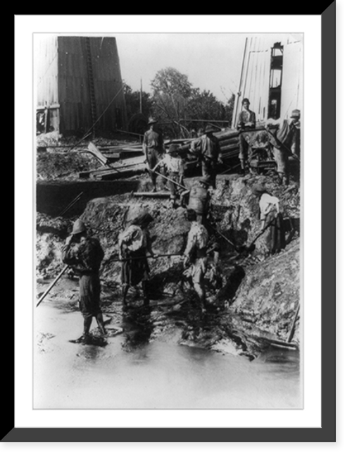 Historic Framed Print, An Earthen Hell. The women dressed in rags stand all day in hot oil shoveling up the refuse to a terrace above them and thence into cars so that not a speck of oil is wasted ...,  17-7/8" x 21-7/8"