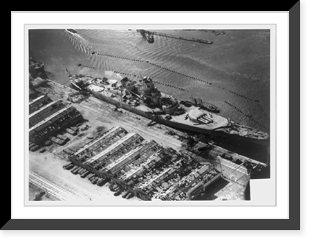View of damage to the unfinished French battleship, Jean Bart, and sheds and pier damaged as the result of bombing and shell fire from U.S. fleet, Casablanca, French Morocco Vintage Wall Art Prin