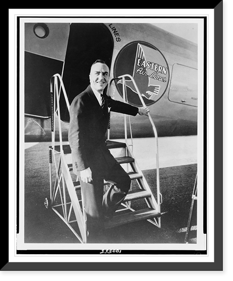 Edward Vernon Rickenbacker, full-length portrait, standing on steps to Eastern Air Lines airplane, facing front, Vintage Print