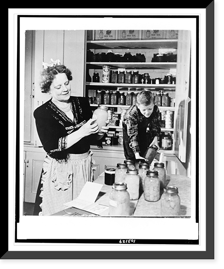 Mrs. Earl Warren, wife of the Governor. of California labels her stock of preserves, aided by her youngest son, Robert, 9 Classic, Antique Poster