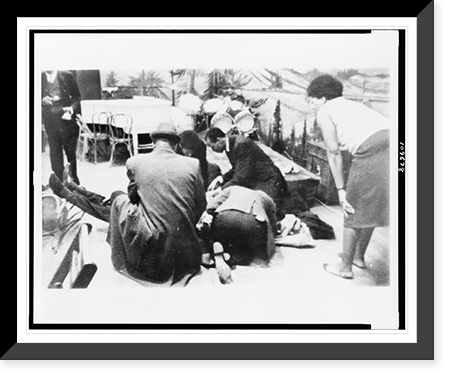 Historic Framed Print, Followers of Malcolm X try to comfort firey renegade of the negro radical movement, as he lies mortally wounded on stage in an upper Manhattan ballroom Feb. 21, after he was cut down by bullets - 2,  17-7/8" x 21-7/8"