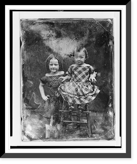 Two unidentified girls, about three and five years of age, the younger child seated in high chair, older one standing beside her on left, both nearly facing front, Antique Print