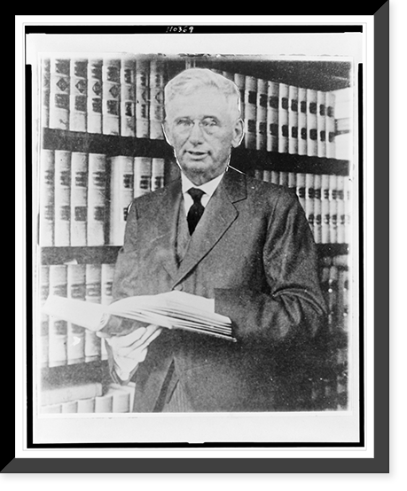 Justice Louis D. Brandeis, half-length portrait, standing, facing slightly left, holding book, in his library, Antique Wall Art