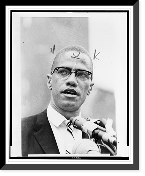 Historic Framed Print, [Malcolm X, head-and-shoulders portrait, facing front, at microphones],  17-7/8" x 21-7/8"