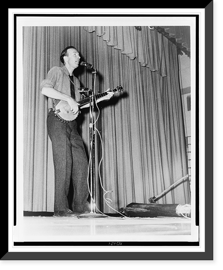Pete Seeger, full-length portrait, performing on stage at Yorktown Heights High School, Yorktown, N.Y..World Journal Tribune photo by James Kavallines, Vintage Print