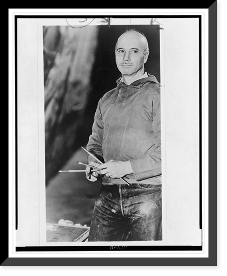 Rockwell Kent, three-quarter length portrait, facing left, holding paint brushes, Antique Print