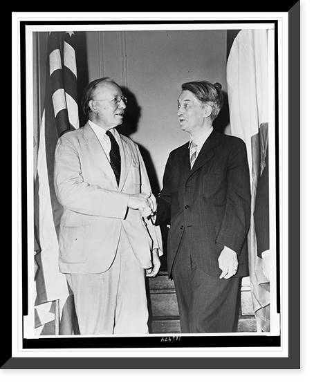 Dr. Alvin Johnson, left in three-quarter length portrait, shaking hands with Jacques Maritain, Antique Poster