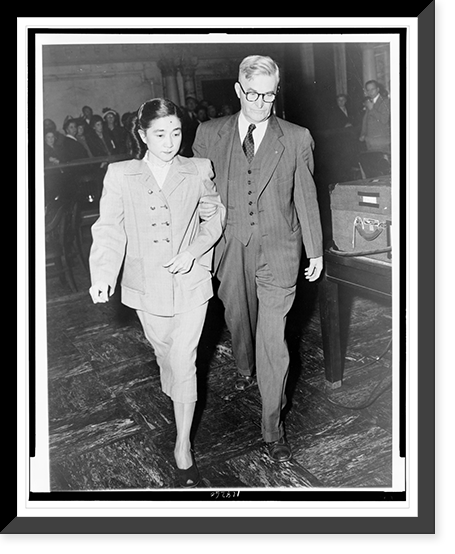Mrs. Iva Toguri D'Aquino (Tokyo Rose), full-length portrait, being led from Federal Court in San Francisco by U.S. Deputy Marshall Herbert Cole, Historic Reproduction
