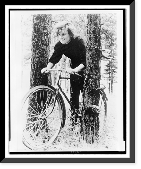 Valentina Nikolaeva-Tereshkova, on bicycle between two trees in wooded area Classic, Antique Print