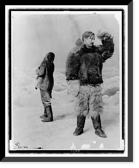 Historic Framed Print, [Frederick Albert Cook, full-length portrait, standing, facing right, wearing fur clothing, in front of arctic" backdrop,  with another man standing behind him]",  17-7/8" x 21-7/8"