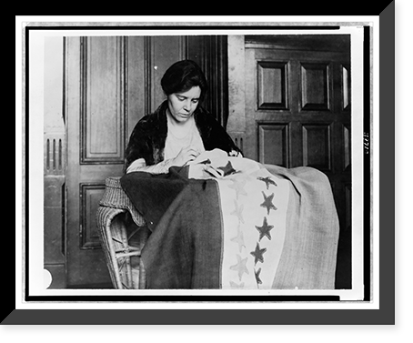 Alice Paul, half-length portrait, seated, facing slightly right, sewing suffrage flag, Vintage Poster