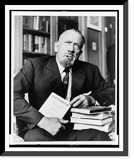 John Steinbeck, three-quarter length portrait, seated, facing front, holding copy of his book Travels with Charley"", Vintage Poster