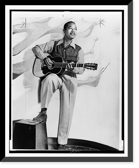 Josh White, full-length portrait, standing, facing right, holding guitar.photo by Albert A. Freeman. Classic, Vintage Poster