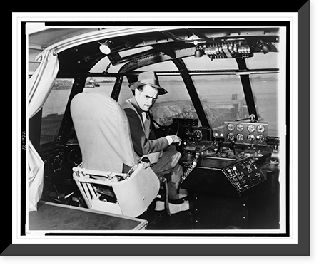 Howard Hughes, seated in cockpit of wooden flying boat, turned right, facing front, Antique Poster