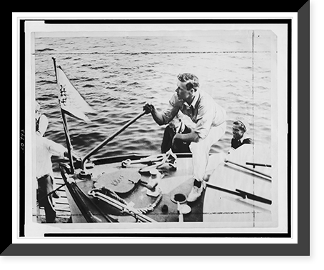 Charles Lindbergh on deck of boat at dock, with hand on tiller, Vintage Wall Art