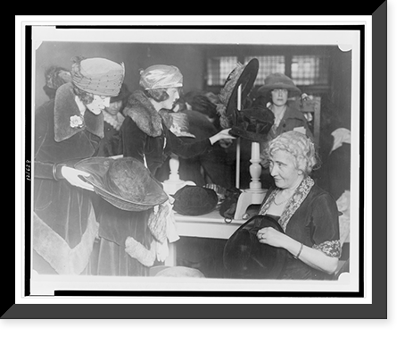 Mrs. Lawrence Townsend at the fourth annual rummage sale of the Child Welfare Society trims discarded hats for the price of one year's milk supply for a Washington baby, Vintage Poster