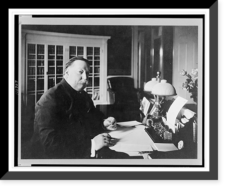William Howard Taft, half-length portrait, seated at desk, facing right, with pen and eyeglasses in his hands, Vintage Wall Art