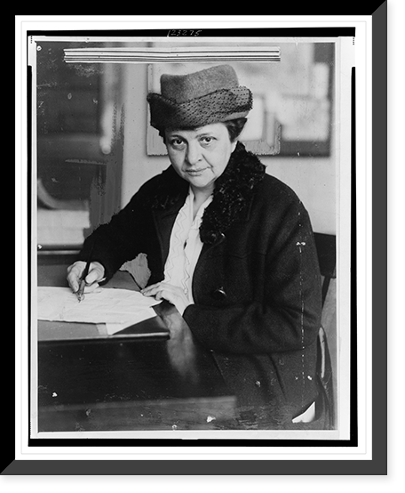 Historic Framed Print, [Frances Perkins, half-length portrait, facing front, signing document],  17-7/8" x 21-7/8"