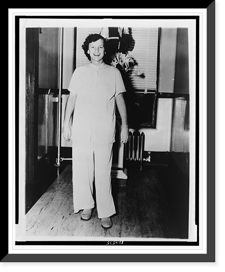 Babe Didrikson Zaharias, full-length portrait, standing, facing front, in pajamas in a Beaumont, Texas hospital following a cancer operation, Historic Print