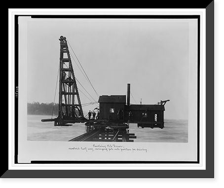 Revolving pile driver; revolved half-way, swinging pile into position for driving, Vintage Print