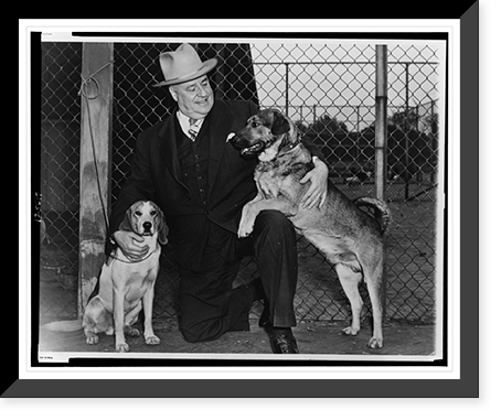 Frank W. Boykin, full-length portrait, kneeling, facing left, holding two dogs, Historic Reproduction