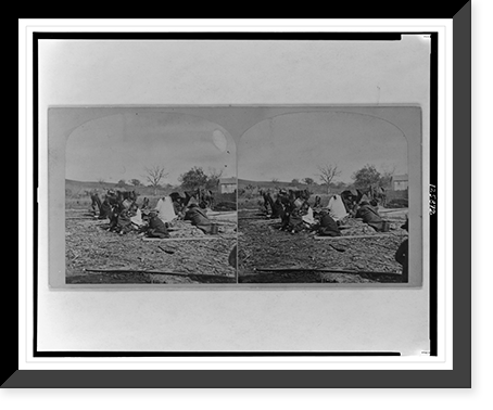 Group of Winnebego Indians seated on ground and logs, Historic Print