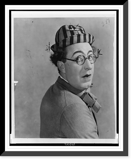 Ed Wynn, head-and-shoulders portrait, in costume as the Perfect Fool", looking over his shoulder", Vintage Print