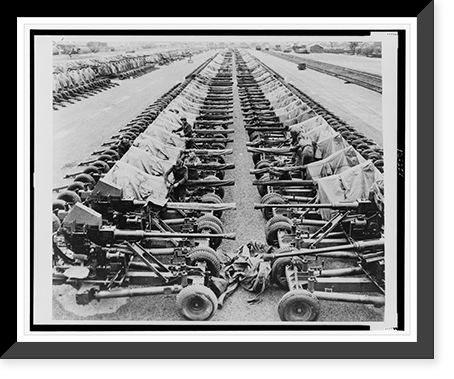 Rows of 40mm Bofors light anti-aircraft(?) guns on Mark II mountings sitting beside railroad tracks in England, in preparation for Allied liberation of Europe, Antique Print