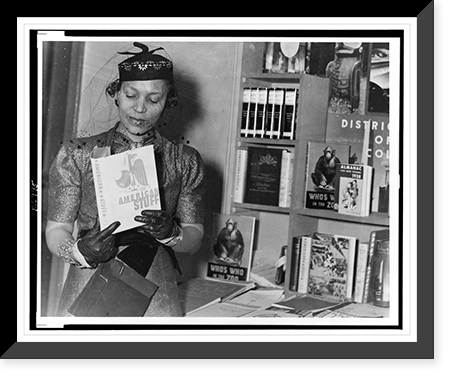 Zora Neale Hurston, half-length portrait, standing, facing front, looking at book, American Stuff, at New York Times Book Fair, Antique Wall Art