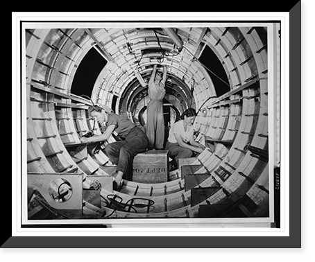 Women workers install fixtures and assemblies to a tail fuselage section of a B-17 bomber at the Douglas Aircraft Company plant, Long Beach, Calif, Historic Reproduction