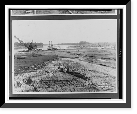 Barge with crane and a steamboat moored at river's edge, in the foreground fissure created by recent floodwaters, a grove of tree stumps in background.Ewing, Inc., Baton Rouge. Heritage Wall Art