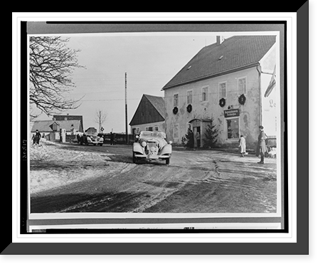 Two Mercedes-Benz automobiles passing in front of a building decorated with wreaths, Vintage Poster