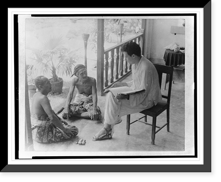 Miguel Covarrubias seated on chair holding sketchbook(?) and talking to two Balinese men, Antique Wall Art