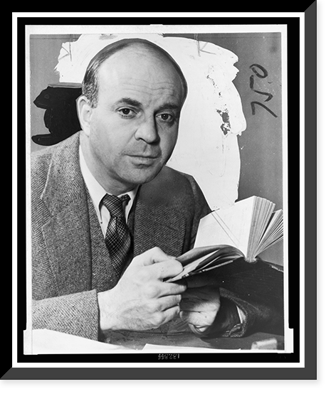 John Dos Passos, head-and-shoulders portrait, facing front, holding book.photo by Eric Schaal, Antique Print