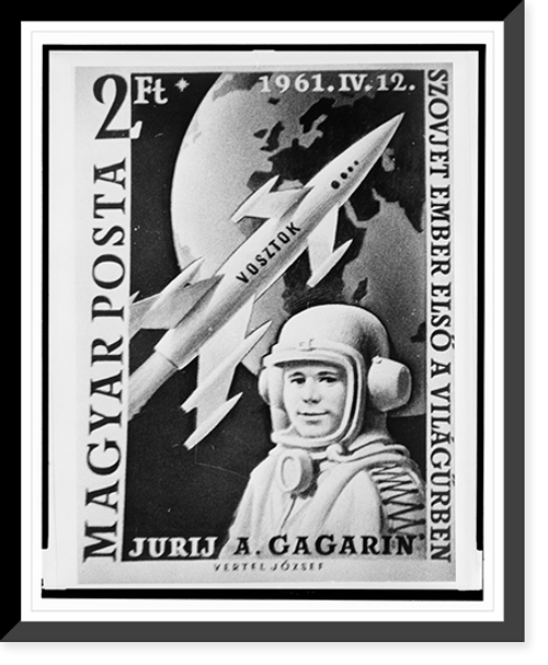 Historic Framed Print, [Hungarian postage stamp depicting Yuri Gagarin, Russian cosmonaut, head-and-shoulders portrait, facing slightly left, wearing space suit and helmet, with rocket and the earth in the background],  17-7/8" x 21-7/8"