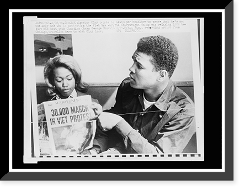 Historic Framed Print, Cassius Clay points to newspaper headline to prove that he's not the only one protesting the Viet Nam war,  17-7/8" x 21-7/8"