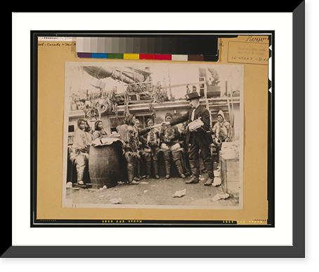 Robert Edwin Peary, full-length portrait, standing on deck of ship or dock, facing left, distributing gifts to Eskimos, Greenland - 2, Antique Poster