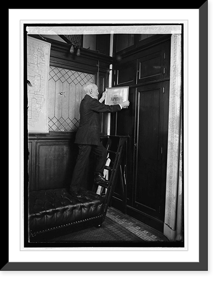 Historic Framed Print, Cannon removing picture from wall, 3/3/23,  17-7/8" x 21-7/8"