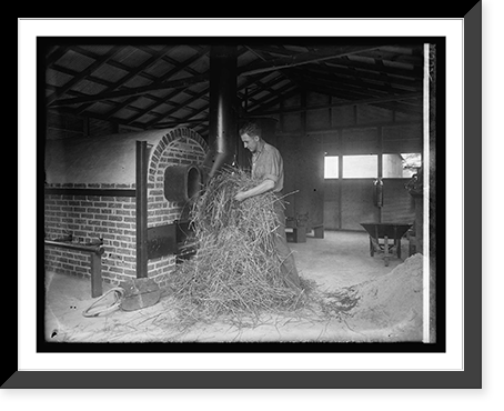 Man handling hay in industrial building, Vintage Poster