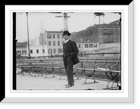Historic Framed Print, Umberto Blaisie standing in front of park benches,  17-7/8" x 21-7/8"
