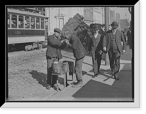 Historic Framed Print, [Man lighting cigarette for another on city street],  17-7/8" x 21-7/8"