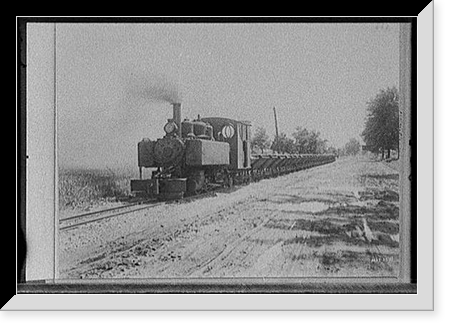 Locomotive pulling cars alongside road, possibly road construction in Michigan Classic, Antique Poster