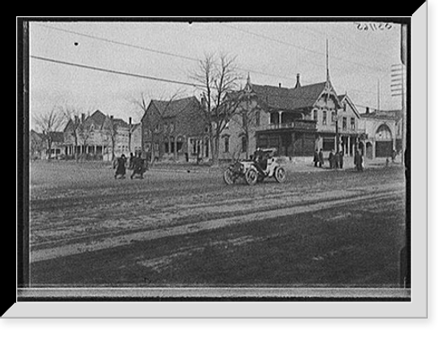 Historic Framed Print, [Street with automobile and Moesta's store],  17-7/8" x 21-7/8"