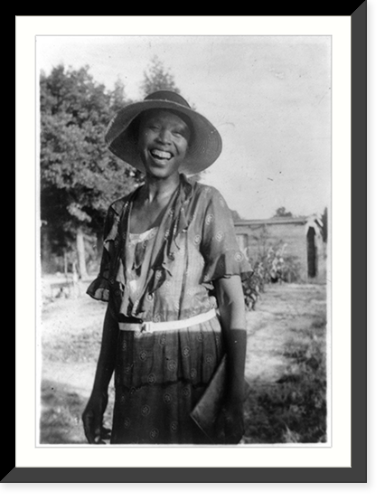 Smiling woman, three-quarter-length portrait of unidentified person standing outdoors, Historic Print