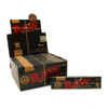 This image features the display box of RAW® Black Rolling Papers King Size Slim, showcasing 50 individual packs. Each pack is prominently displayed, highlighting the sleek and sophisticated black design that sets RAW® Black apart. The image captures the fine texture of the ultra-thin papers, emphasizing their premium quality. The distinctive RAW® branding is visible, reinforcing the product's authenticity and appeal to discerning smokers