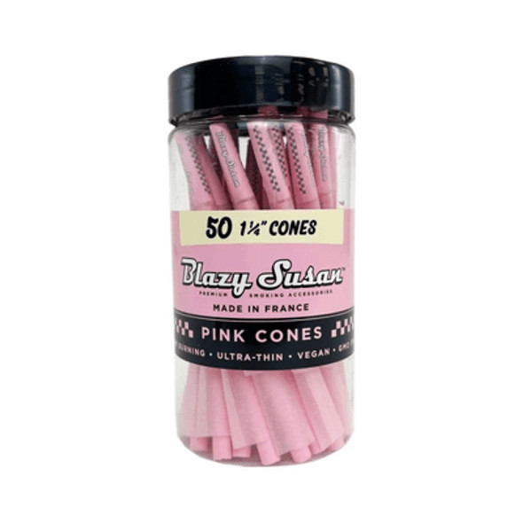 A chic jar of Blazy Susan 1 1/4 Pink Pre-Rolled Cones, featuring 50 high-quality, ultra-thin cones in a vibrant pink color. Crafted from vegan and non-GMO materials, these cones are made in France for a premium, slow-burning smoking experience. Perfect for those seeking a stylish and eco-friendly option.