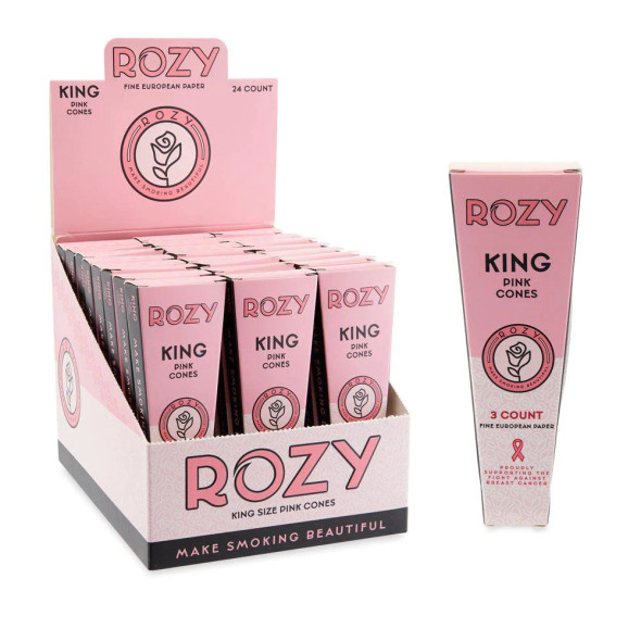 A 24ct display box of Rozy Pink King Size Pre-Rolled Cones, featuring individual 3-pack boxes. Each pack includes three bright pink pre-rolled cones with filter tips and a packing stick for easy filling. The display box is designed to attract attention with its vibrant pink packaging and distinctive rose logo, perfect for catching the eye on any retail shelf.