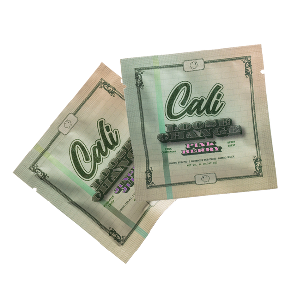 Open package displaying the Cali Extrax Loose Change Gummies in both Jungle Juice and Pink Berry flavors, arranged to showcase the texture and vibrant color indicative of their rich, fruity taste.