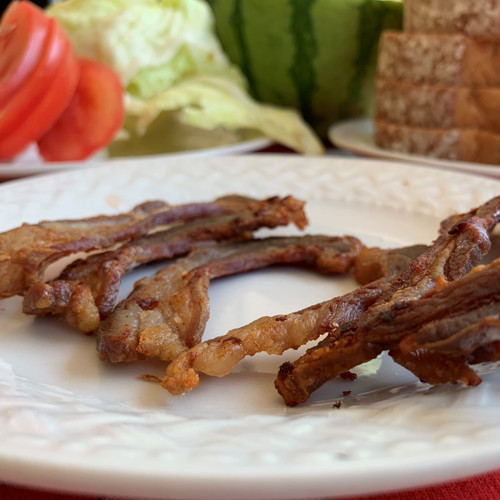 cooked lamb bacon and fixing for LBLT (lamb bacon, lettuce and tomato)